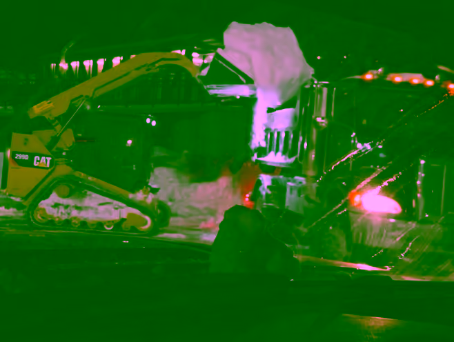 Night snow removal with an excavator on a Pittsburgh property