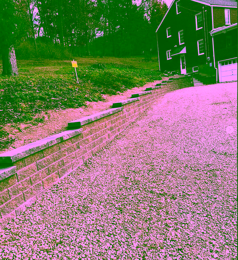 Block retaining wall with gravel driveway